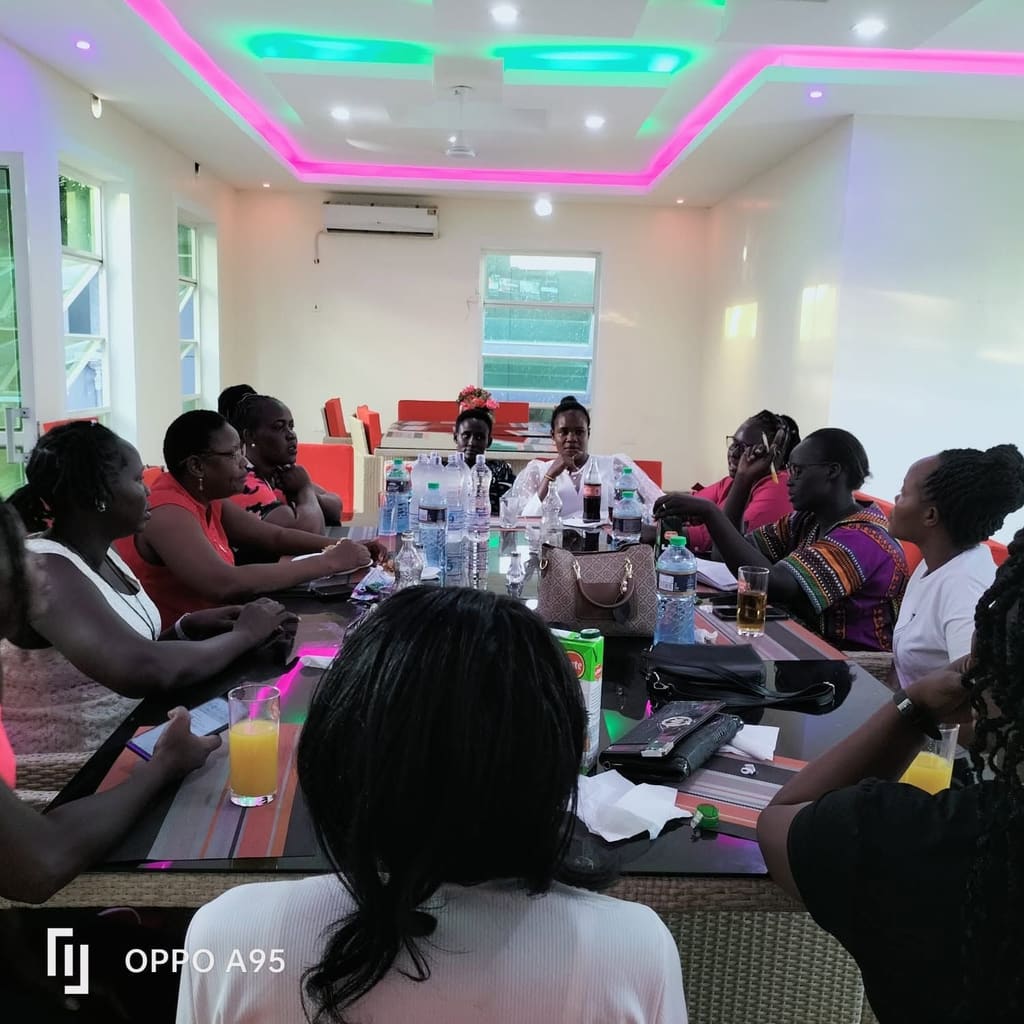 A meeting in progress at Cherinas Homes, with guests seated around long tables.