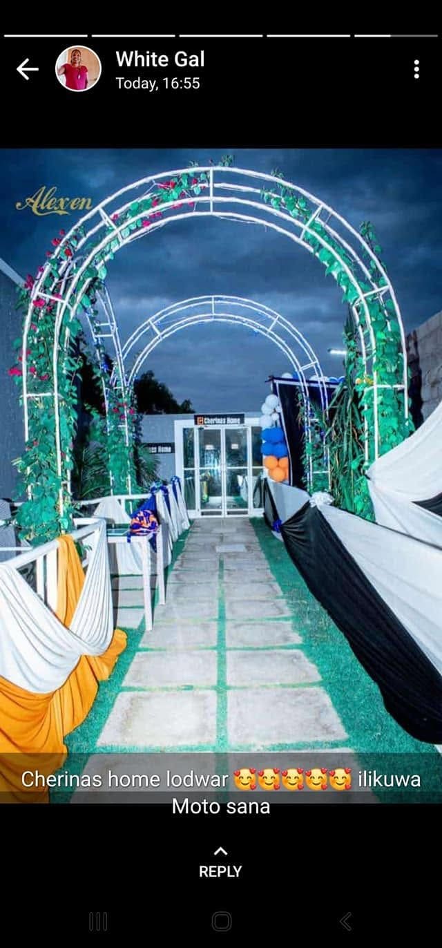 A walkway at Cherinas Homes dressed with white drapes and greenery for an event.