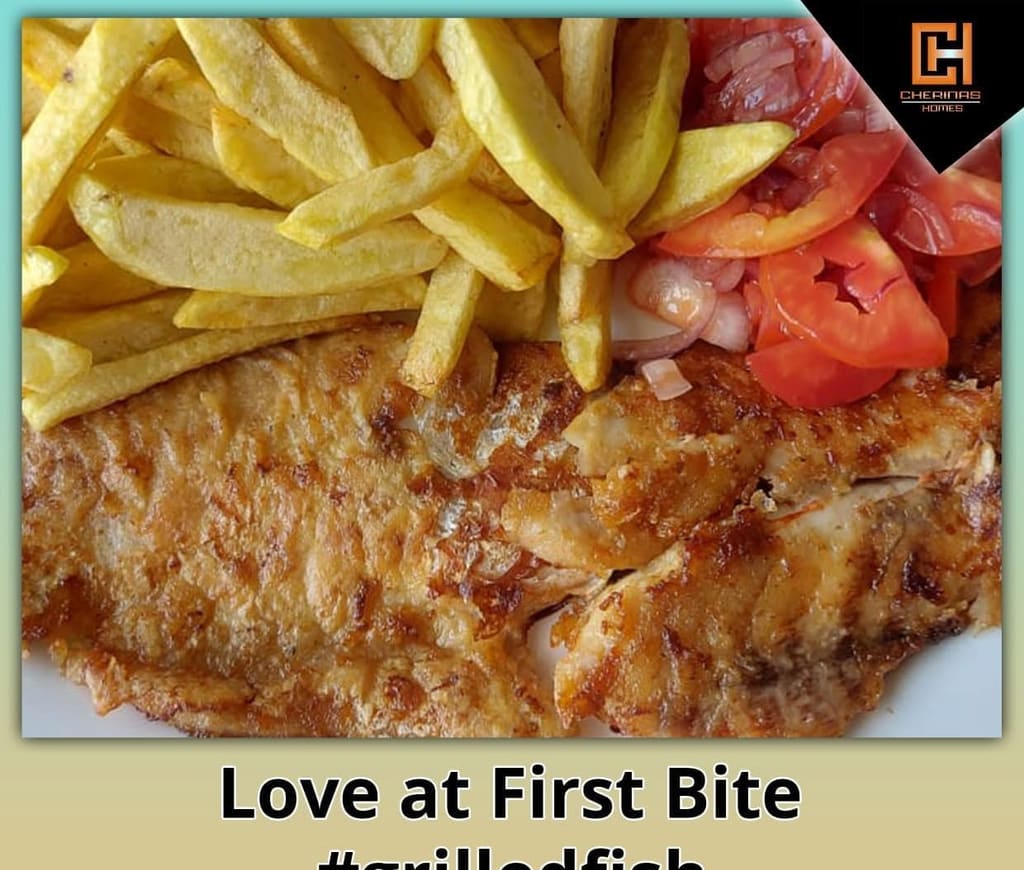 Grilled fish with chips and tomato at Cherinas Homes.